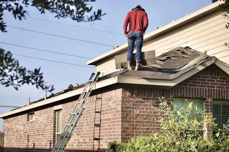 Professional roofer working on a residential roof in Hereford